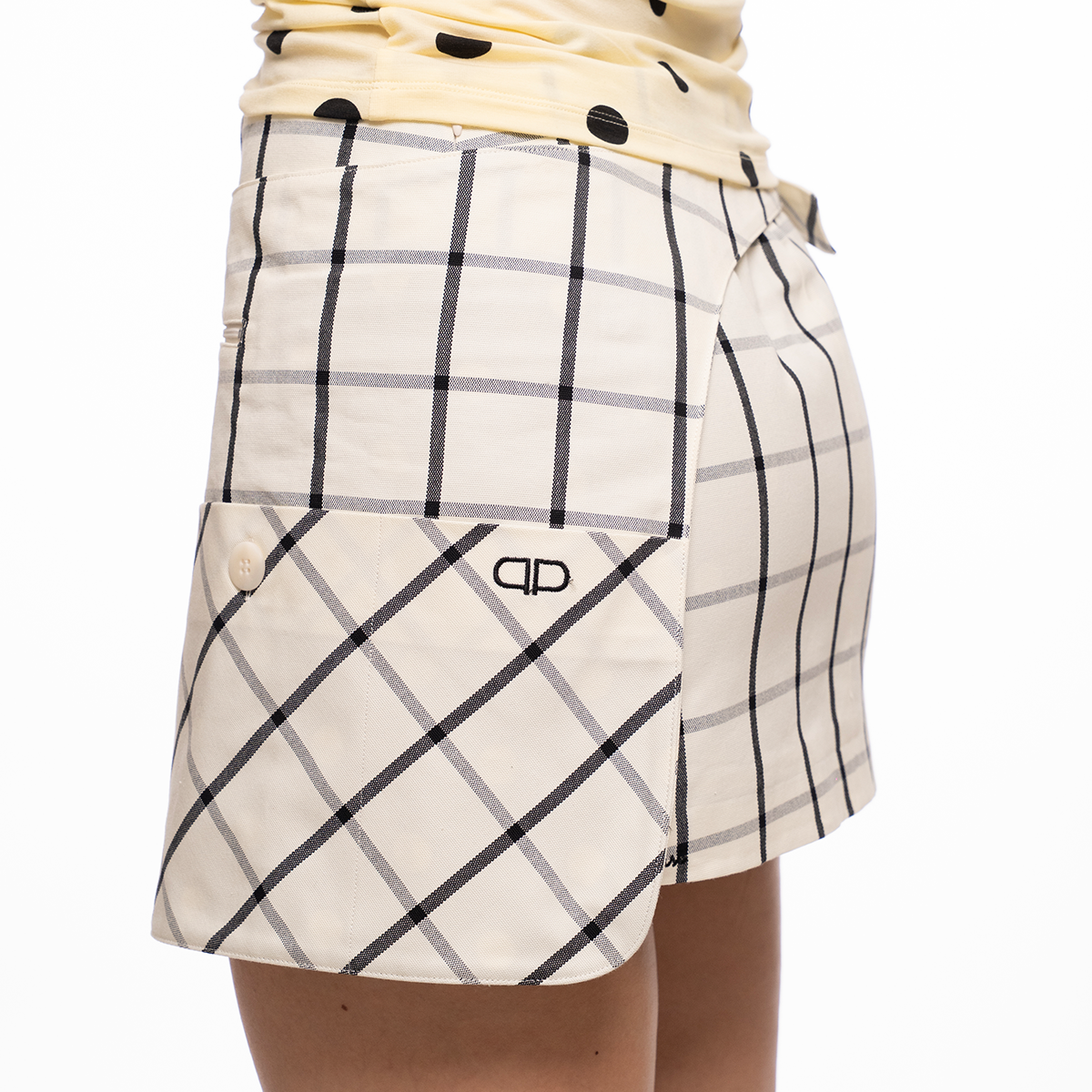 White checkered skirt with a brand logo on a white background