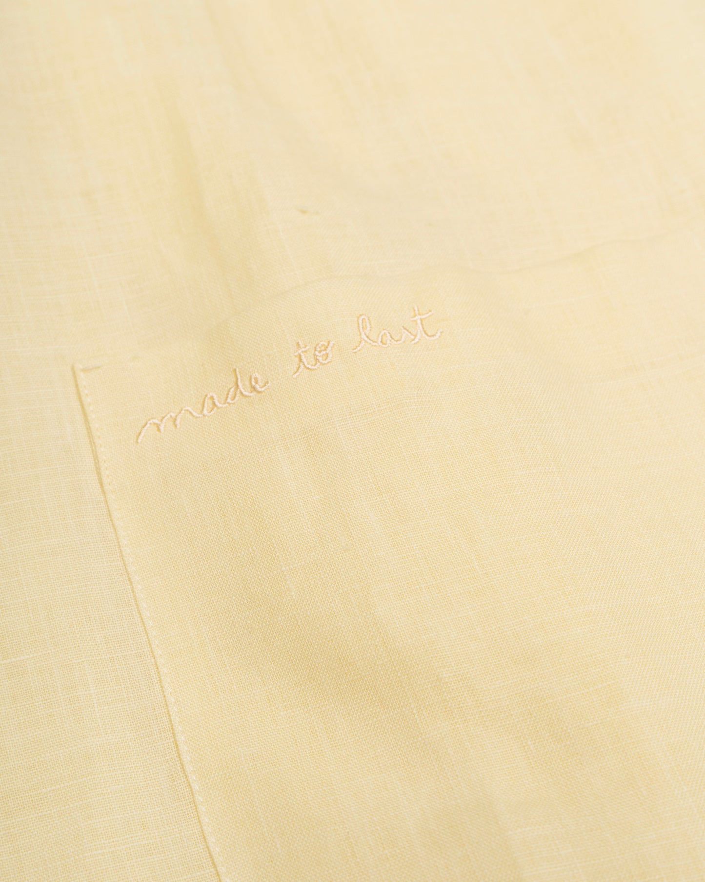 Yellow dress with 'made to last' branding
