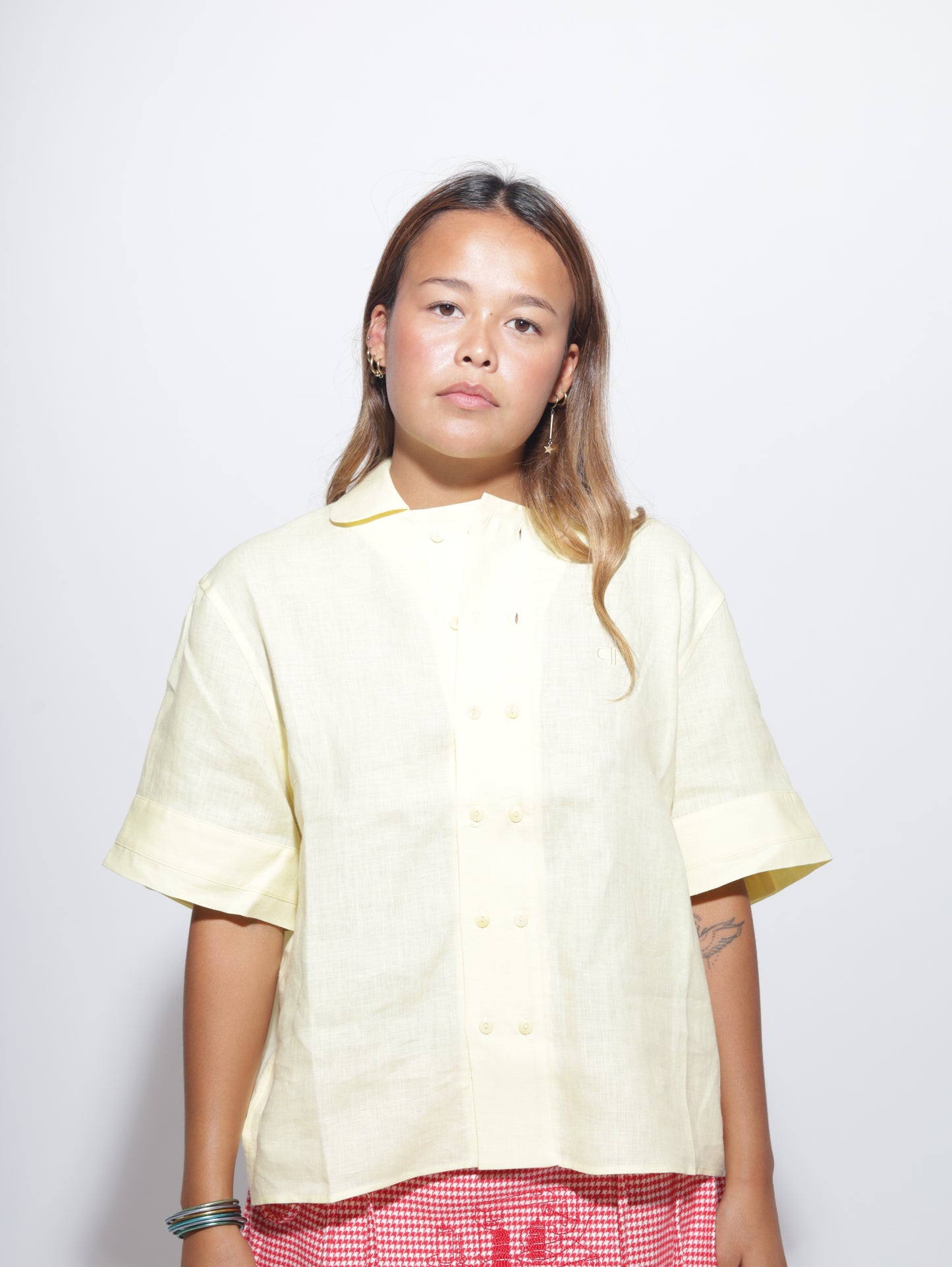 Woman wearing a light yellow button up shirt