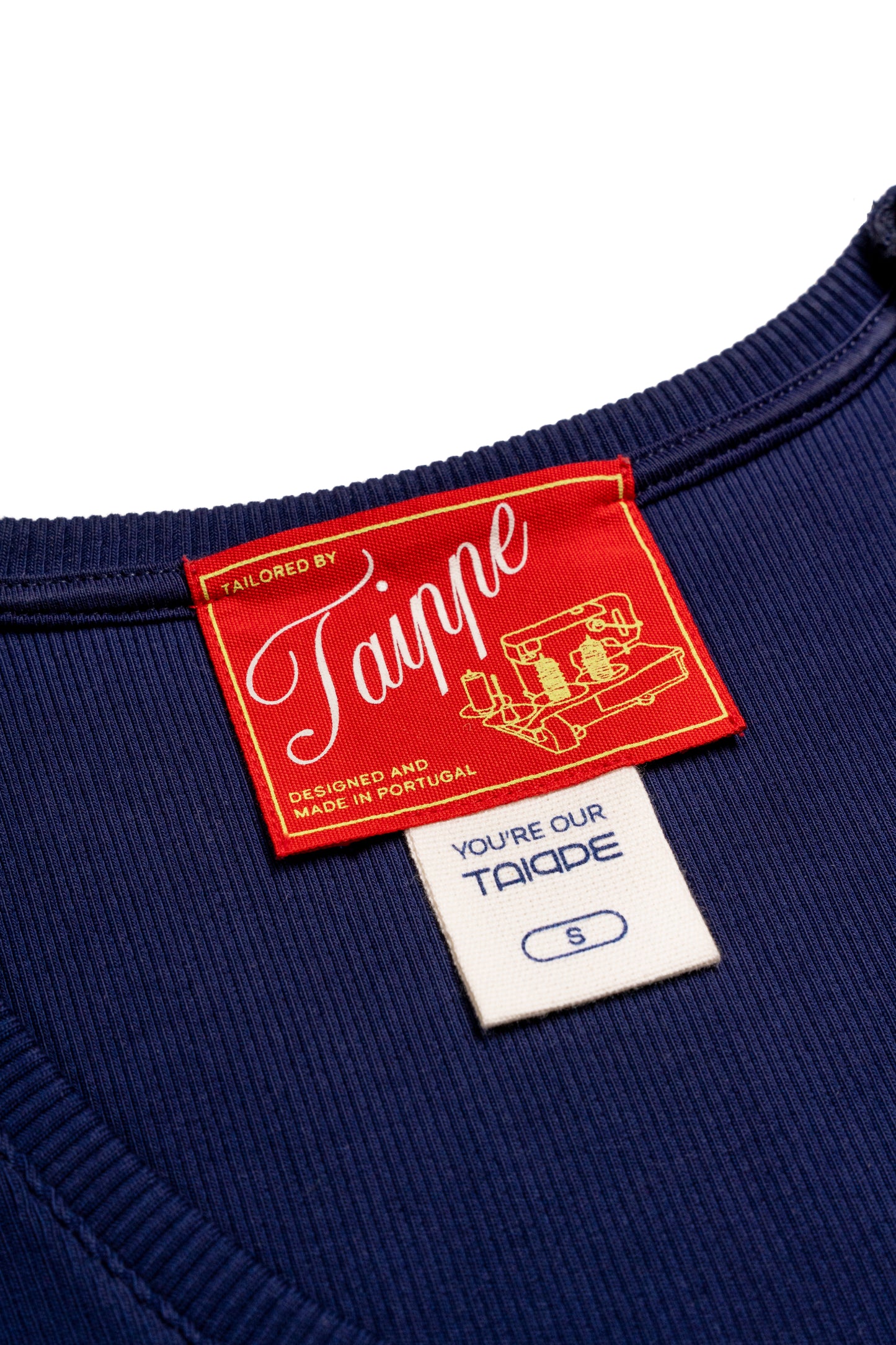 Navy tank top with a red and white label on a white background