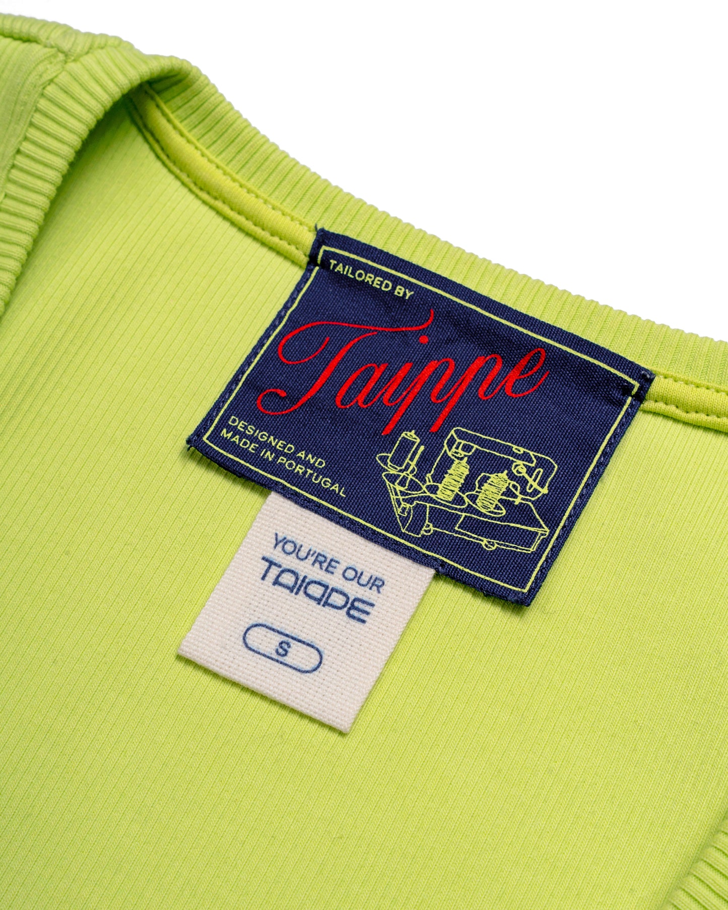 Close-up of a lime tank top with a 'Tailored by Taippe' label on a white background