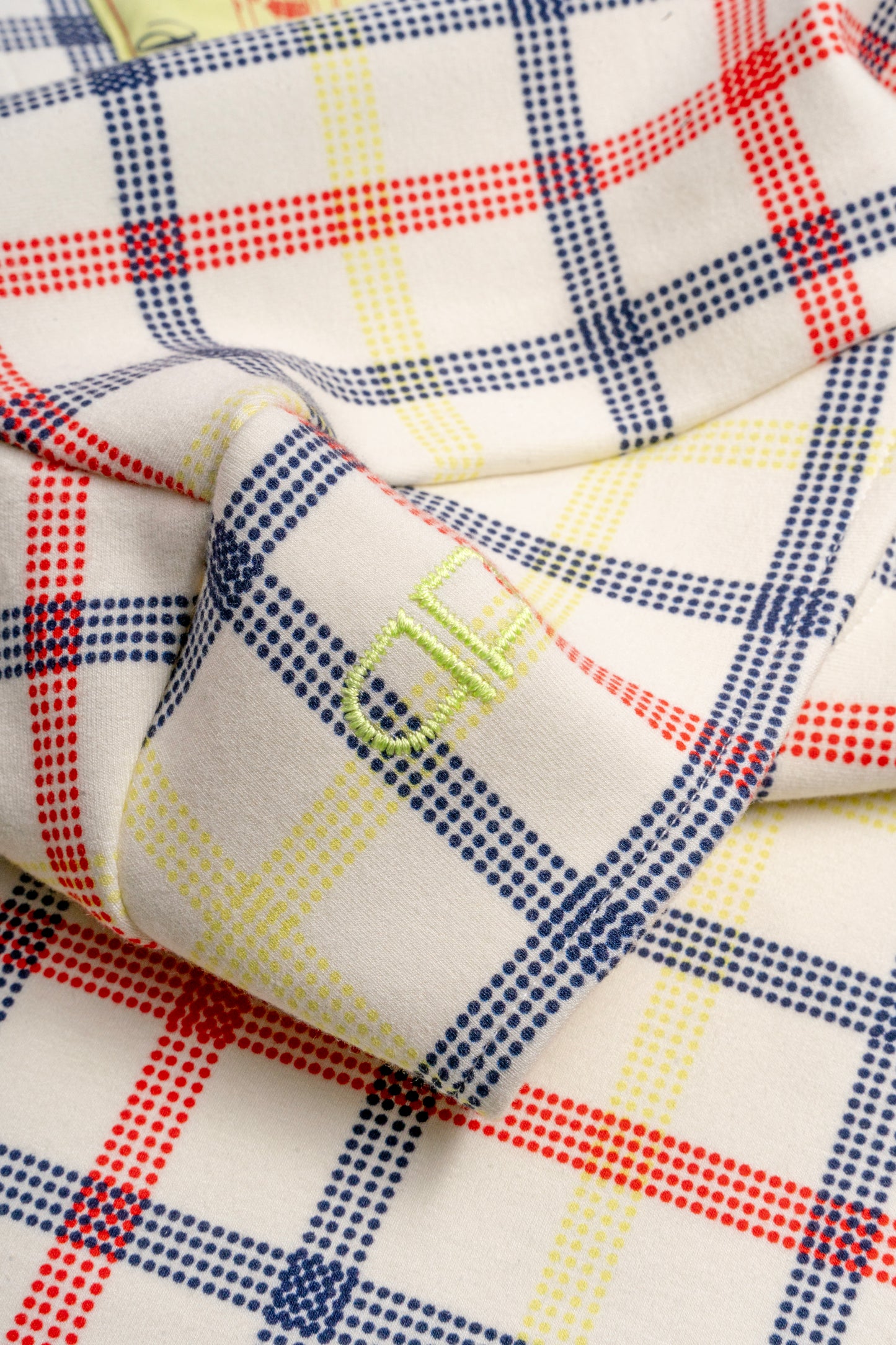 Close-up of plaid fabric with red, blue, and yellow patterns