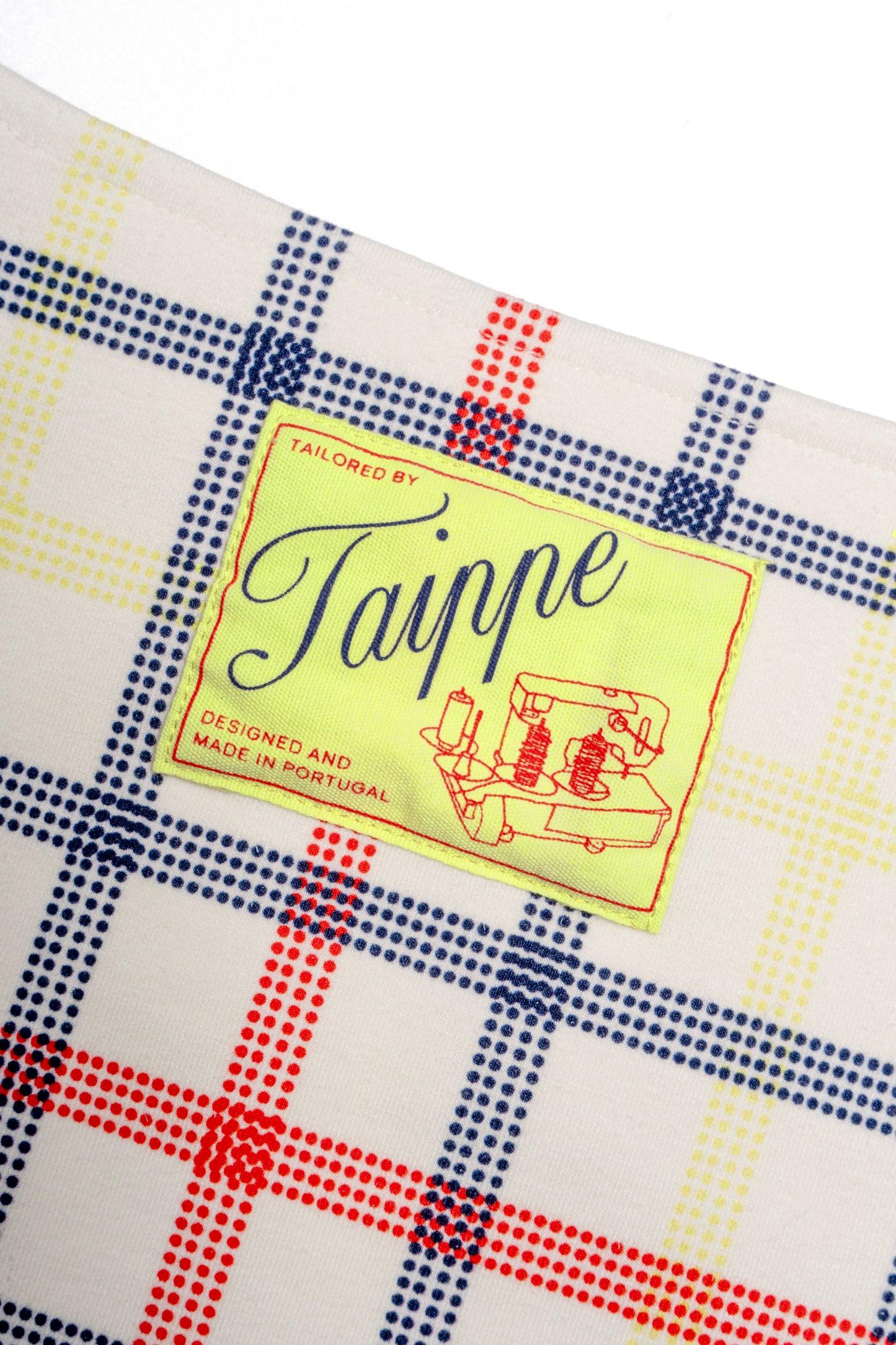 Checkered dress with a Taippe label on a white background