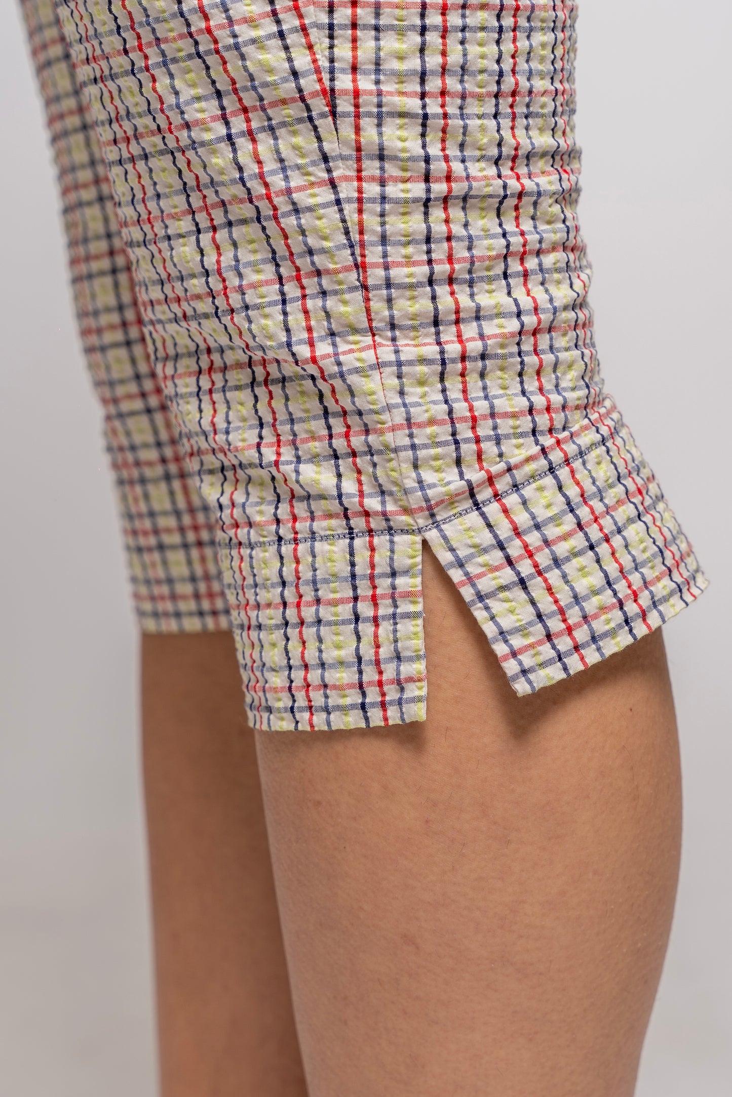 Multicolored plaid capris with a slit on a plain background