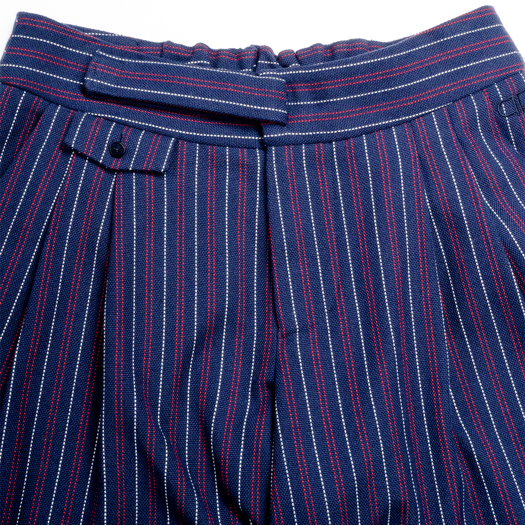 Close-up of blue pinstripe pants with a belt on a white background