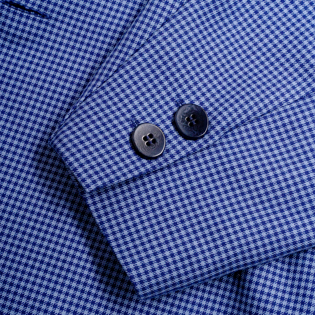 Close-up of a blue checkered blazer with a button 
