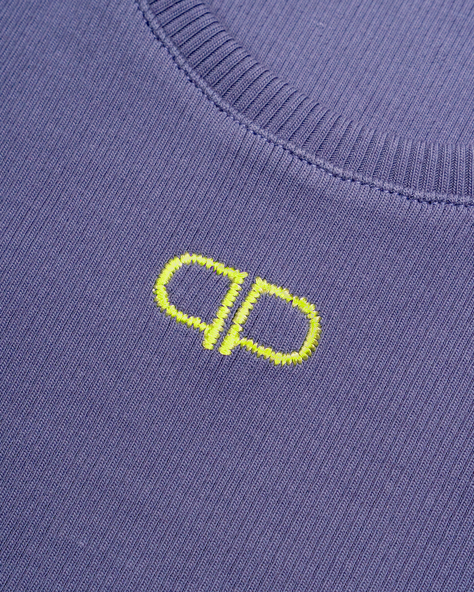 Close-up of a blue tank top with a yellow logo on a plain background