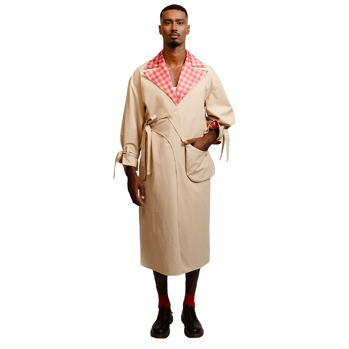 Man wearing a beige coat with a red and white gingham collar 