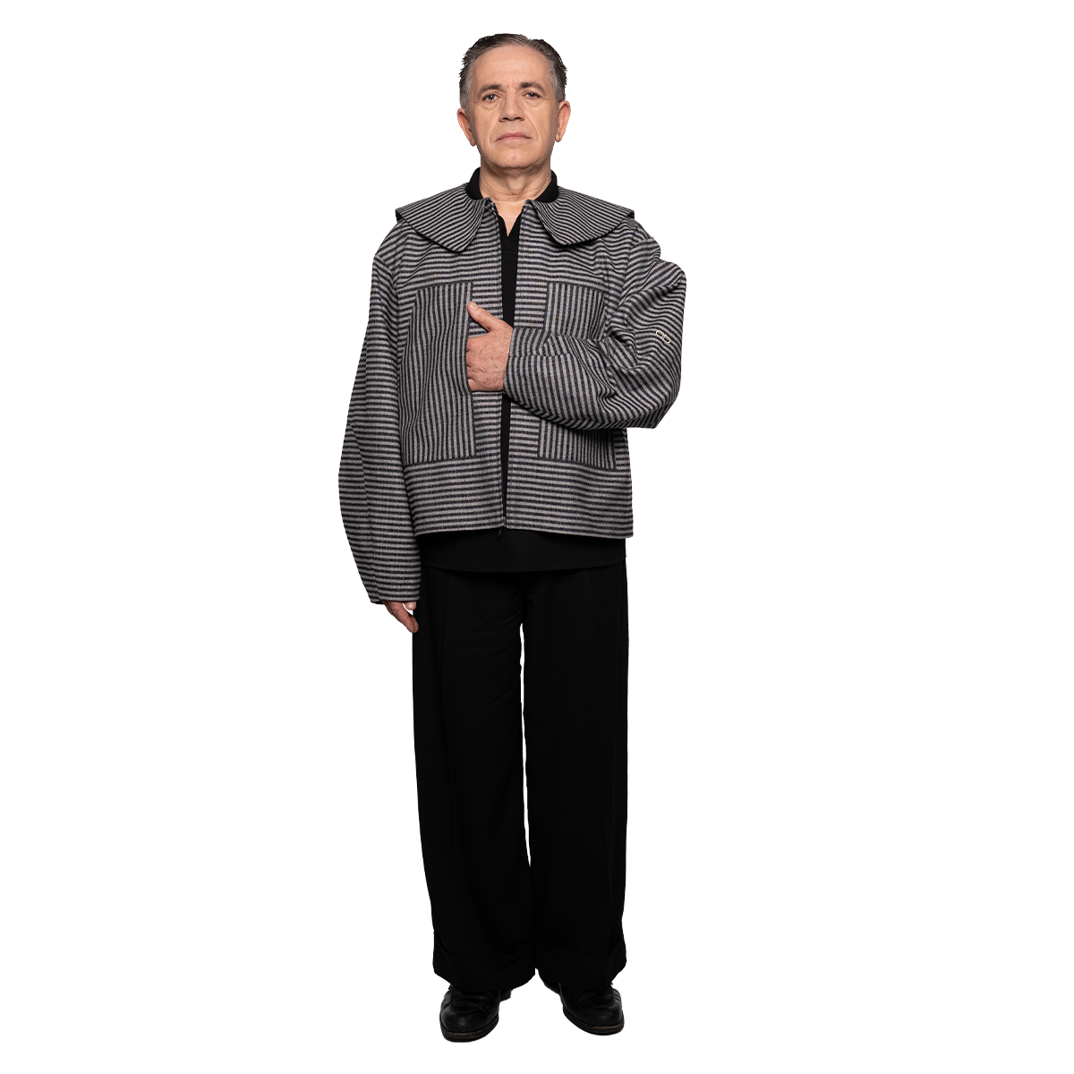 Person wearing a black and grey striped jacket on a white background