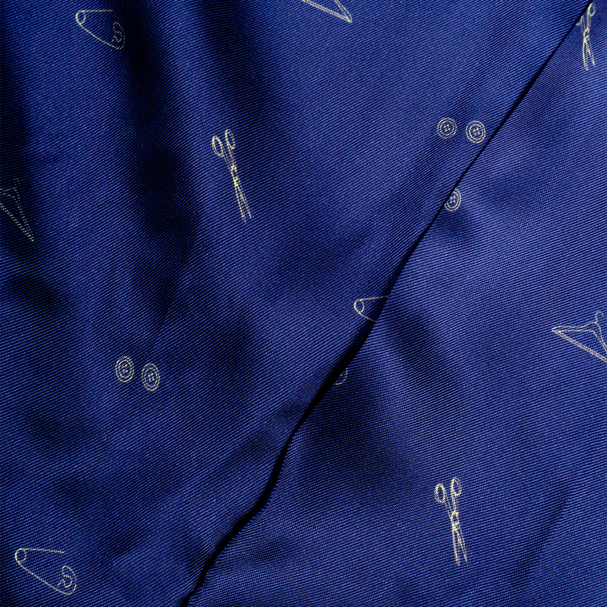 Close-up of the lining of a blazer with small white icons on a dark background