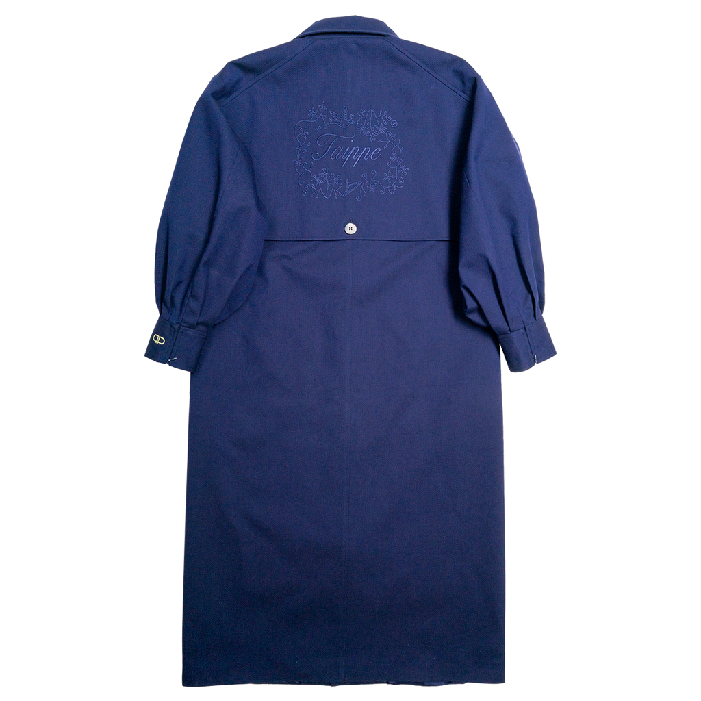 Navy blue coat with embroidered design on the back against a white background