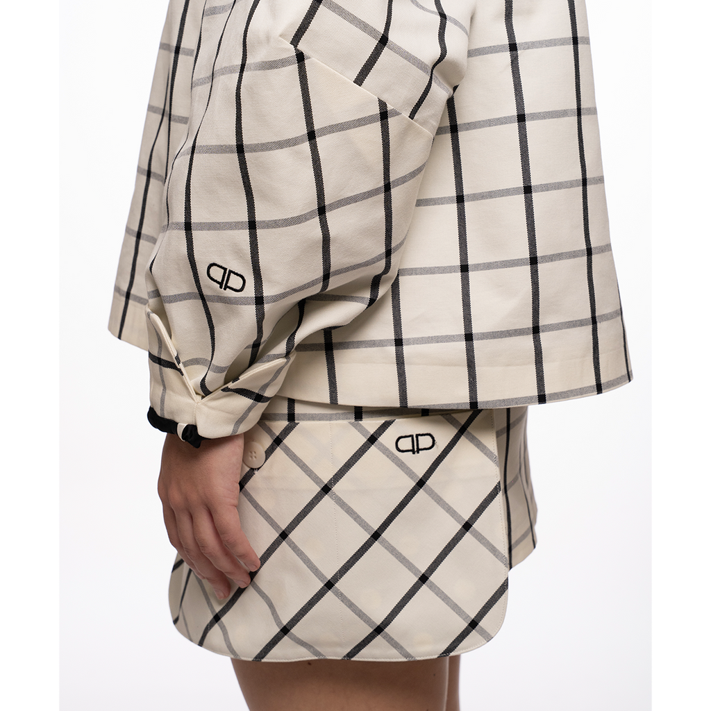 White and black checkered outfit with brand logo on a white background