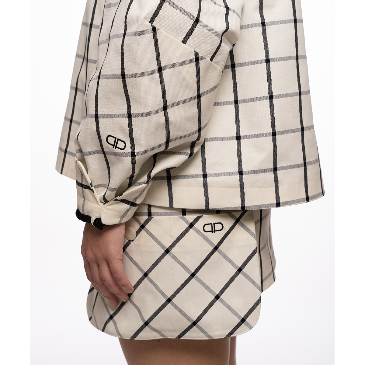 White and black checkered outfit with brand logo on a white background