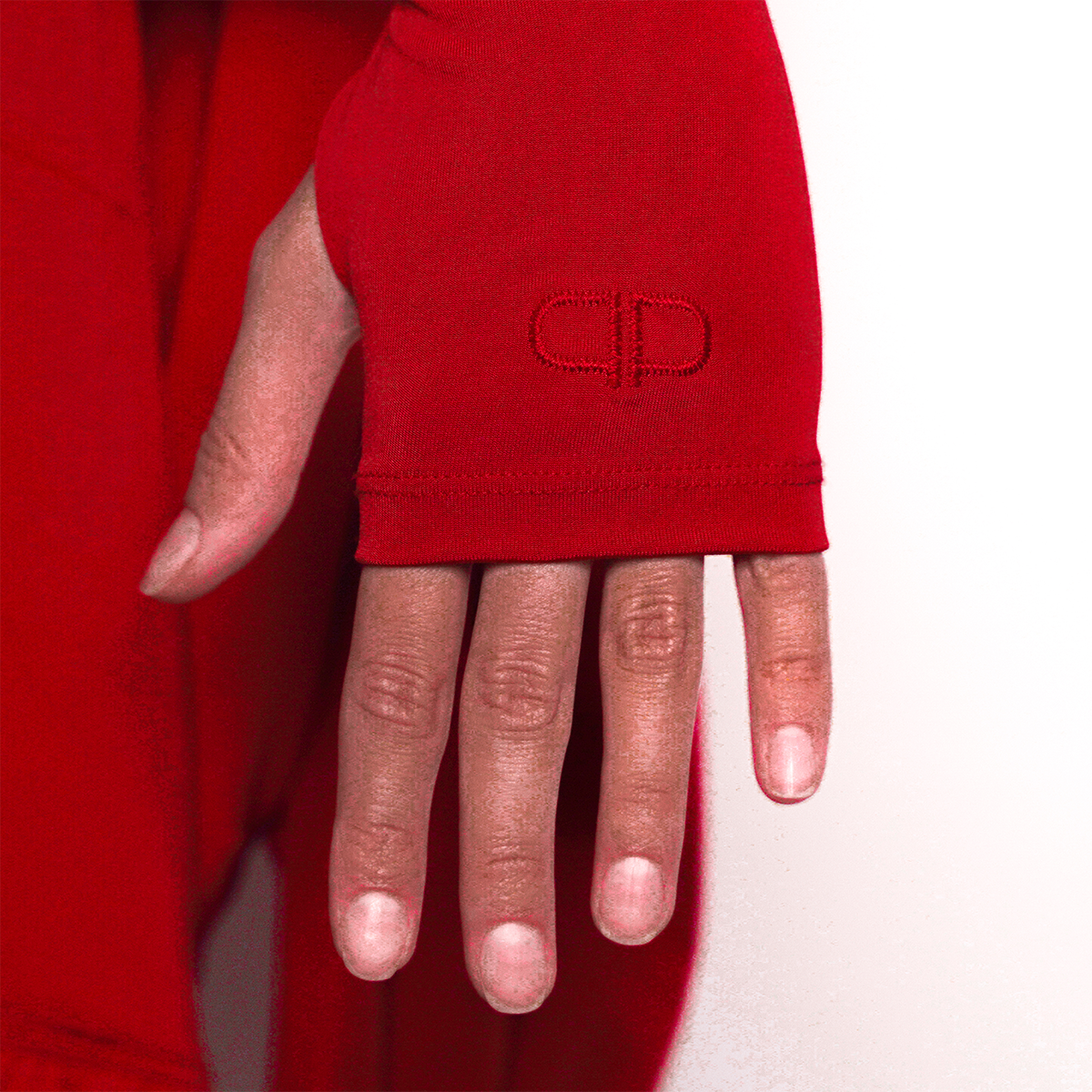 Red sleeve of a dress with a logo on a white background