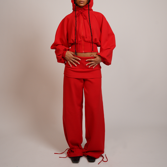 Person wearing a red outfit with wide-leg pants