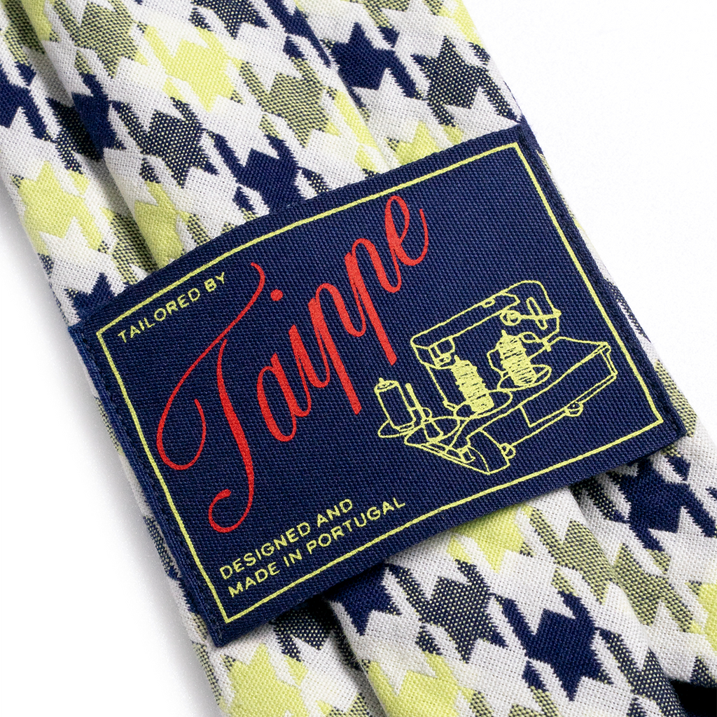 Patterned tie with a 'Tailored by Taippe' label on a white background