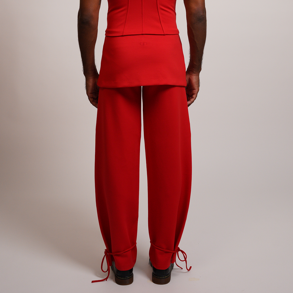 Person wearing a red outfit with wide leg pants 