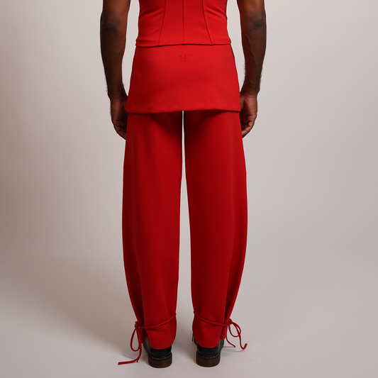 Person wearing a red outfit with wide leg pants 