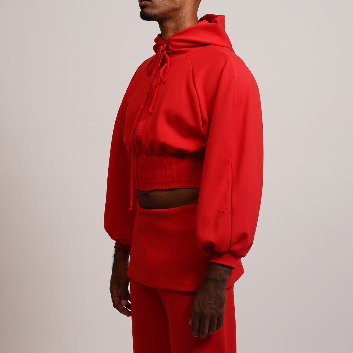 Person wearing a red cropped hoodie