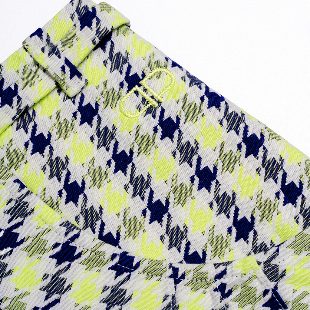 Close-up of a patterned skirt with blue, green, and white colors on a white background