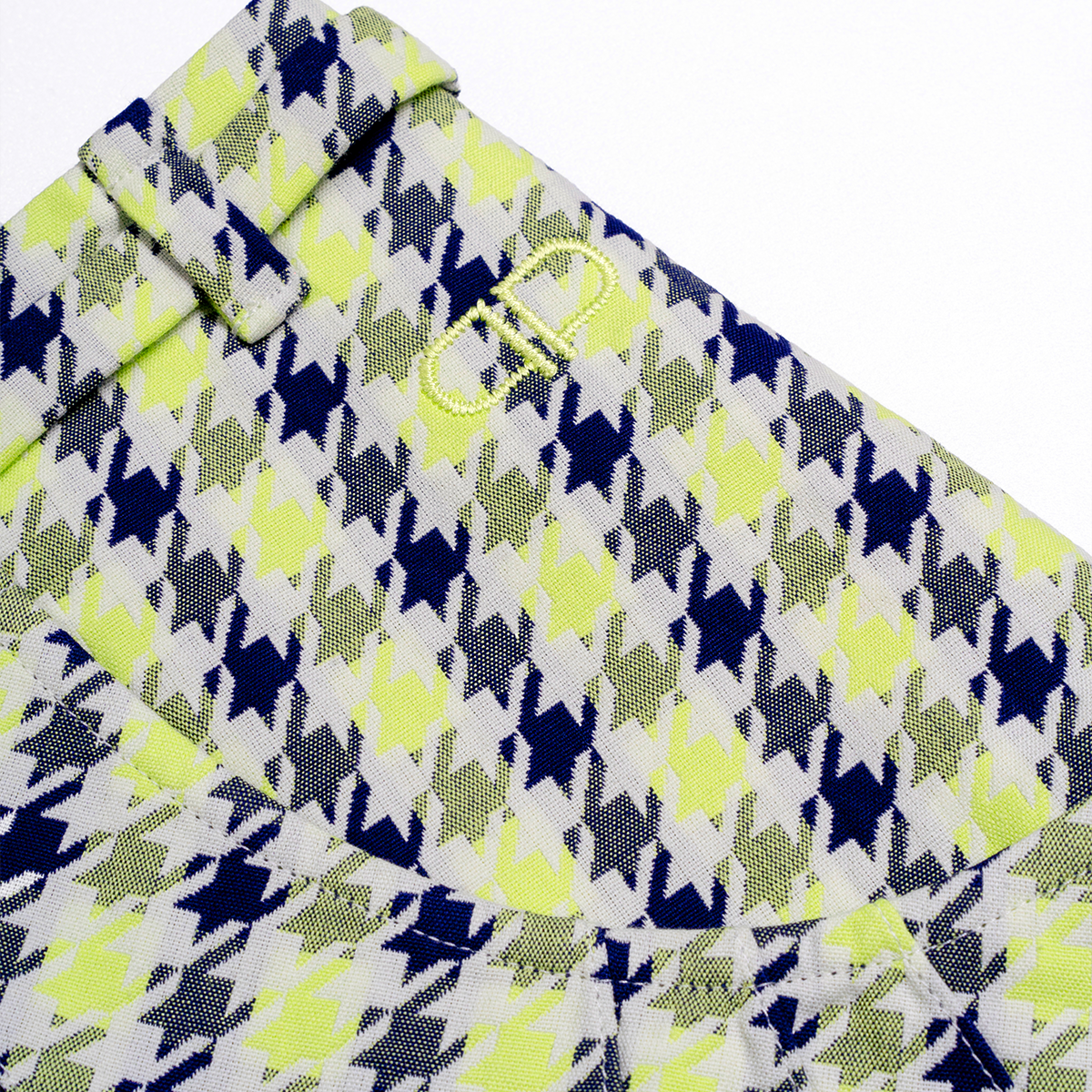 Close-up of a patterned skirt with blue, green, and white colors on a white background