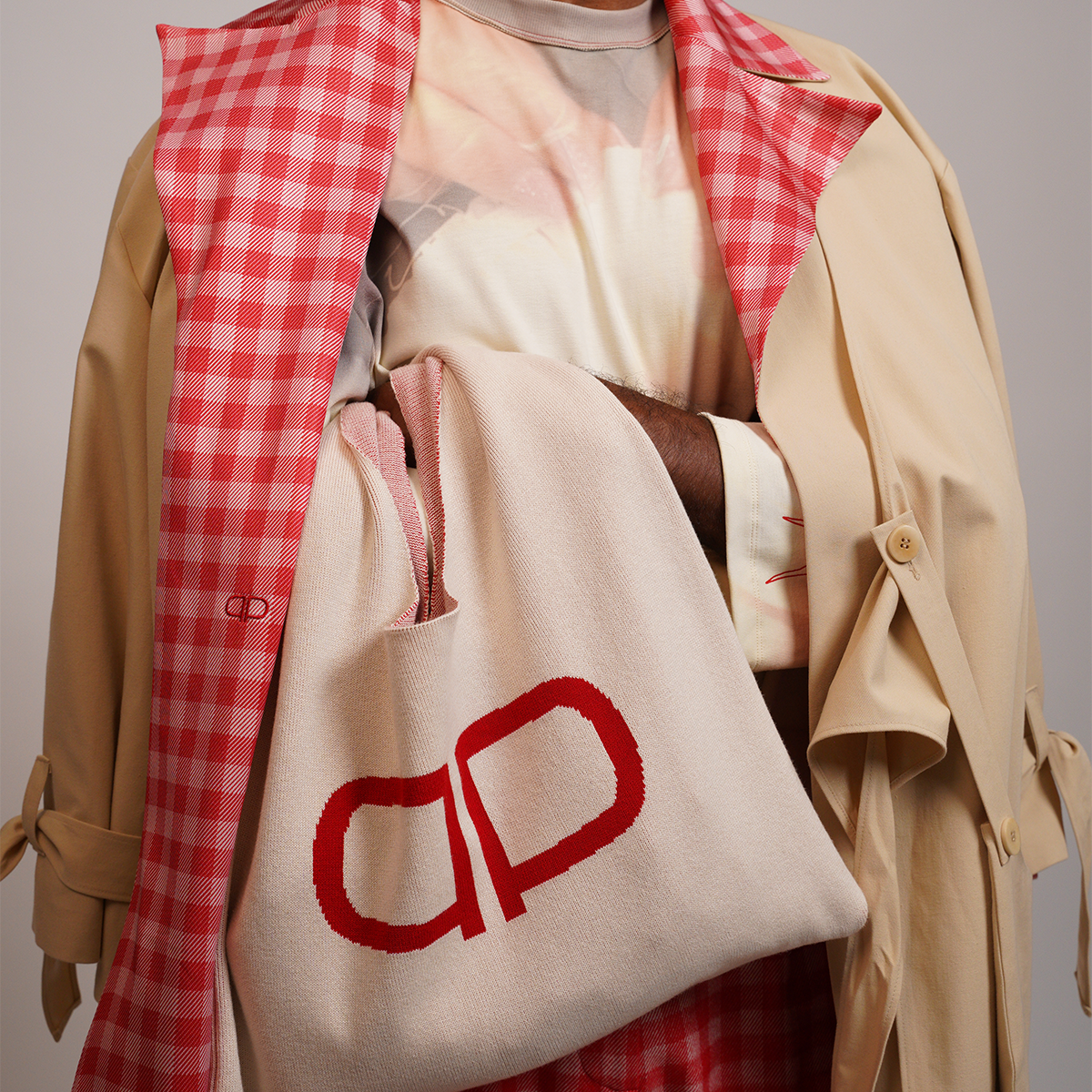 Person wearing a beige trench coat with gingham lining 
