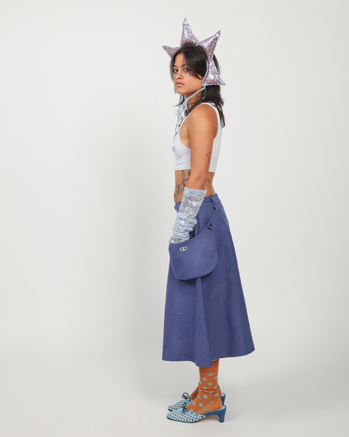 Person wearing a blue skirt on a white background.