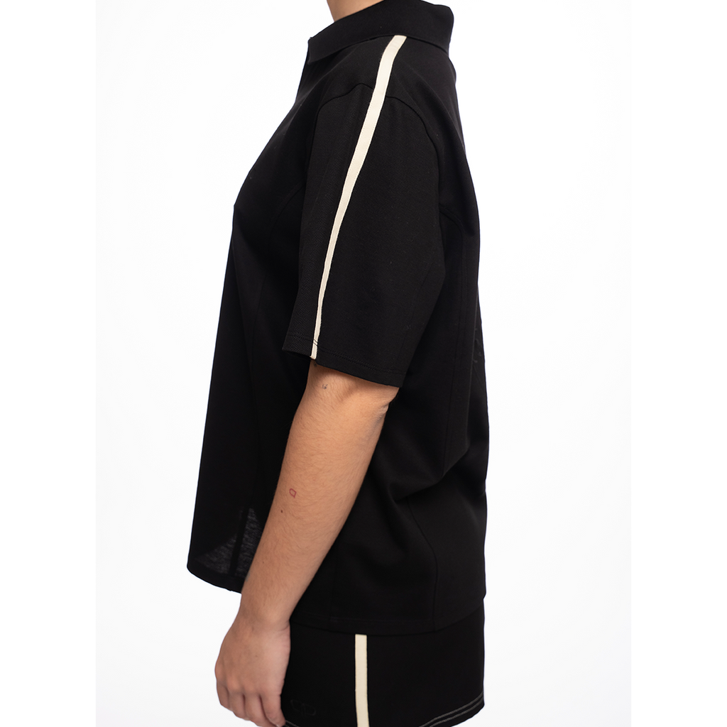Black outfit with yellow trim on a white background
