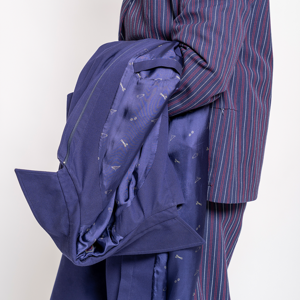 Blue coat with a striped suit on a white background