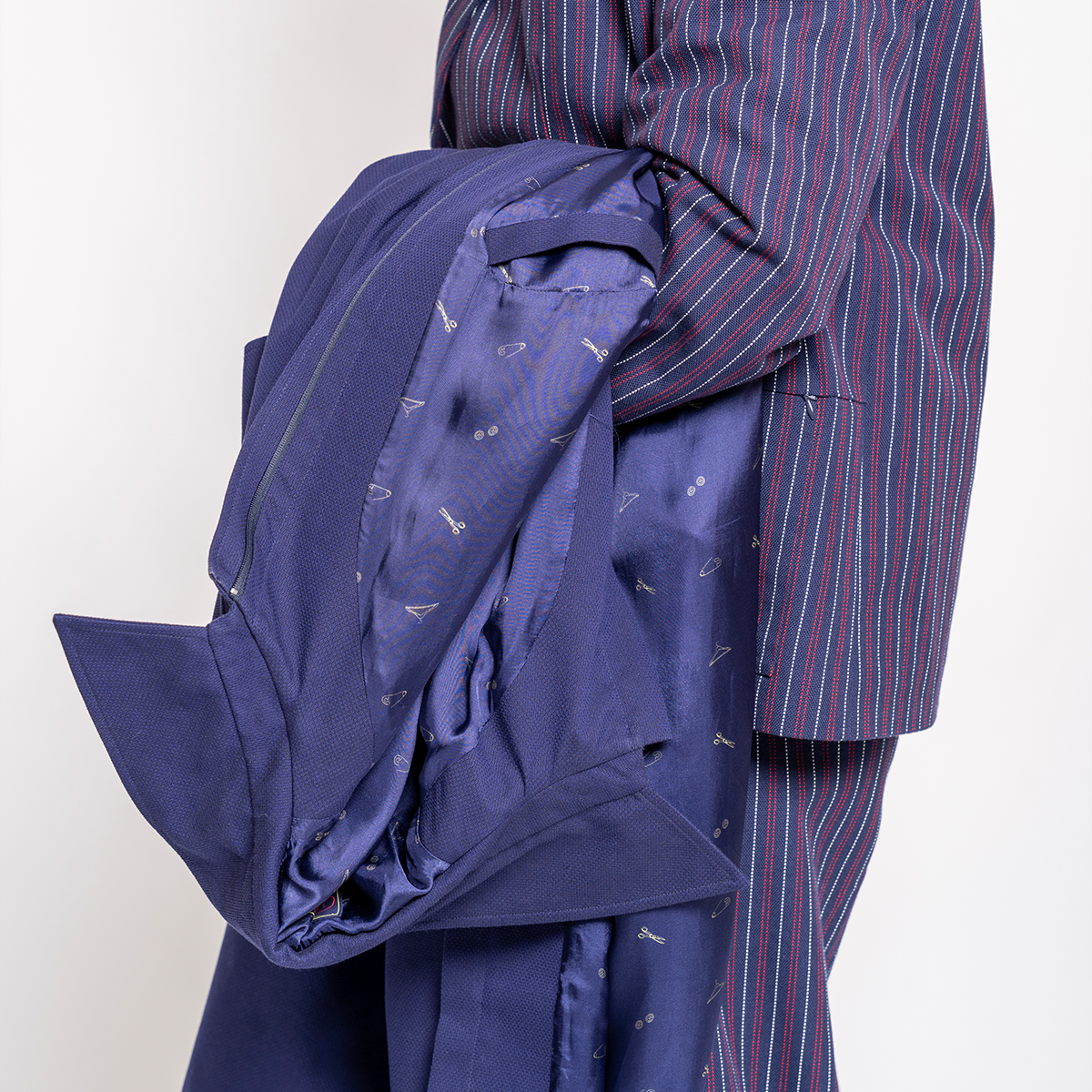 Blue coat with a striped suit on a white background