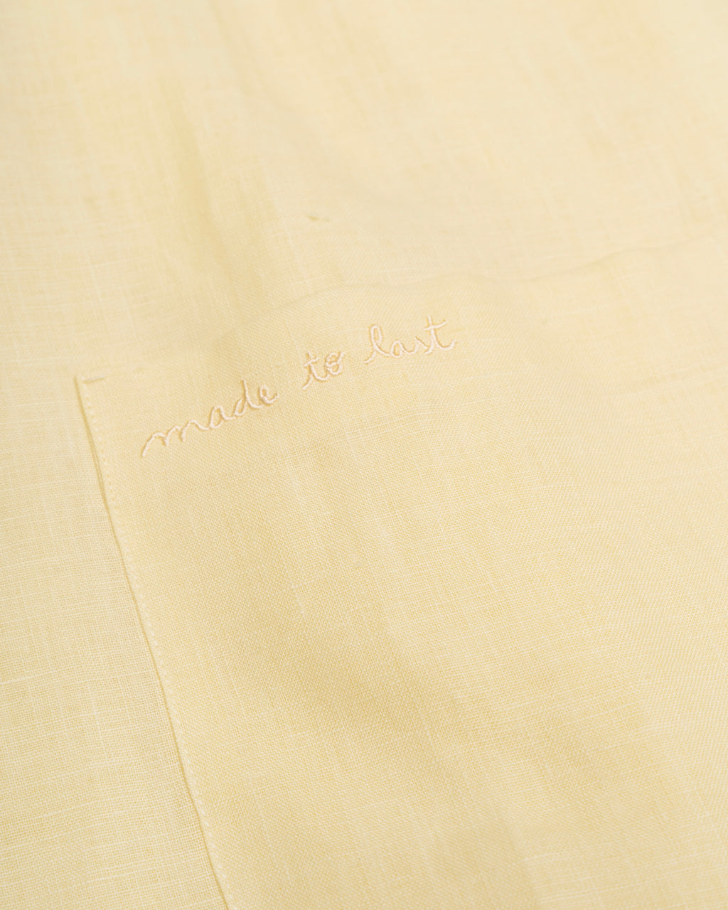 Yellow dress with 'made to last' branding 
