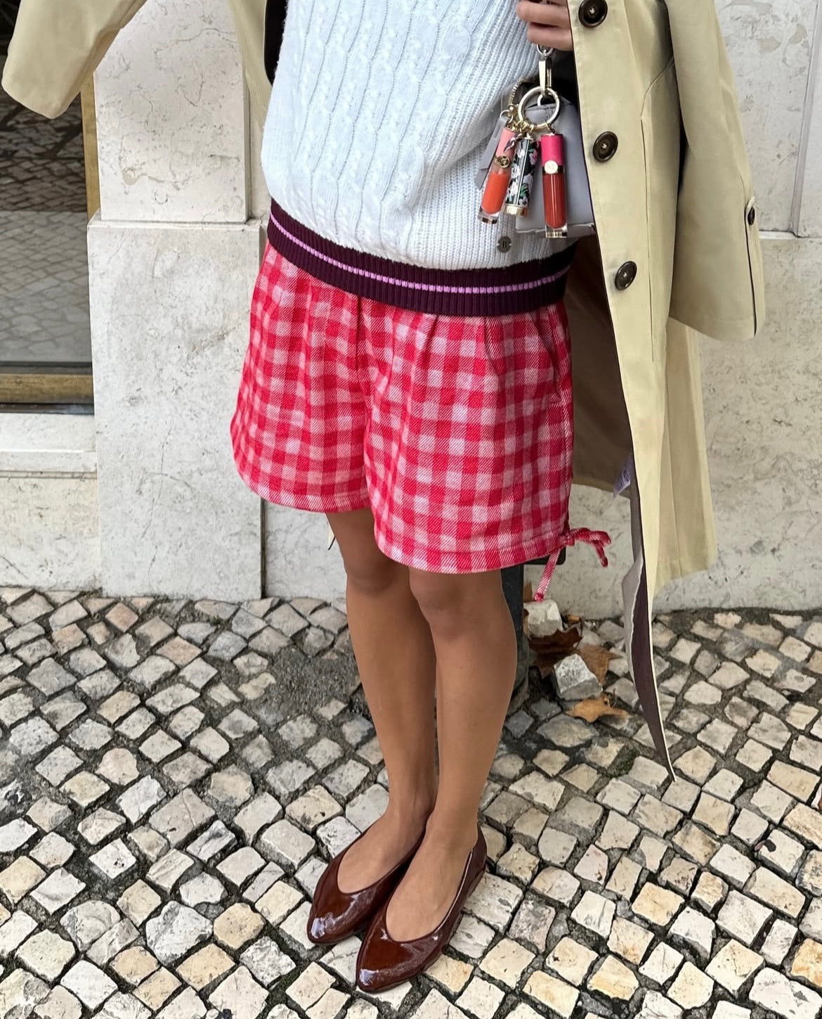 Person wearing red checkered shorts