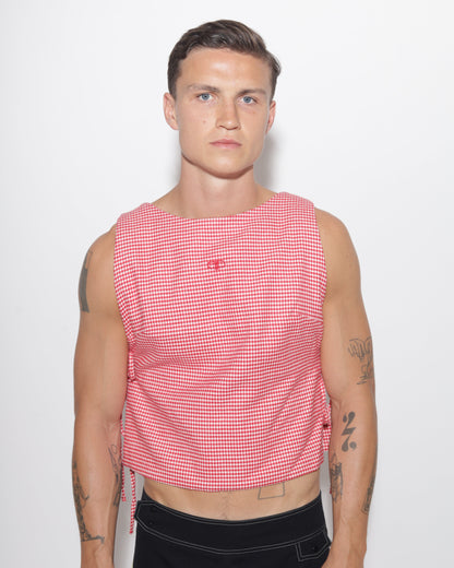 Person wearing a red and white checkered vest on a white background