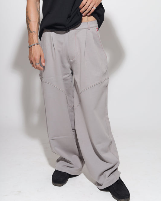 Person wearing gray pants with a white background