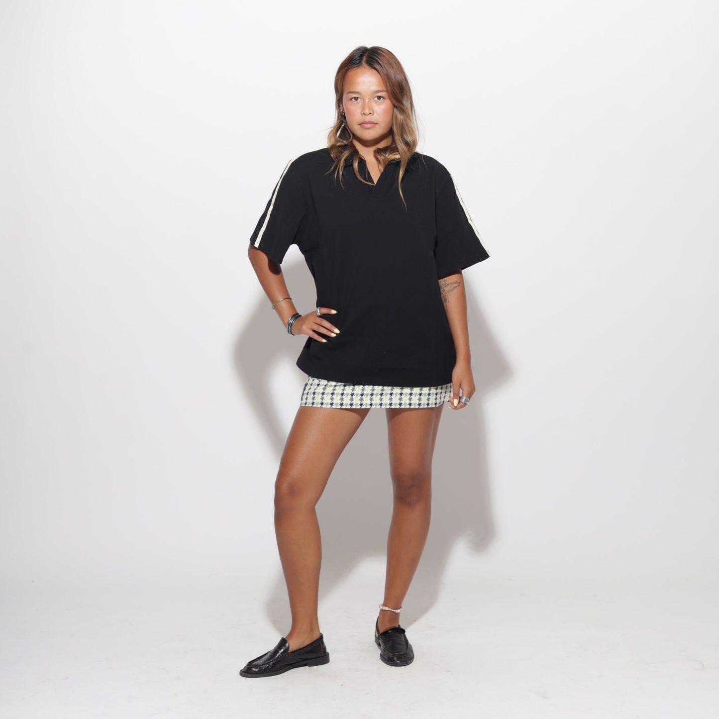 Person wearing a black outfit with a white background