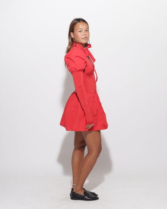 Person wearing a red dress on a white background