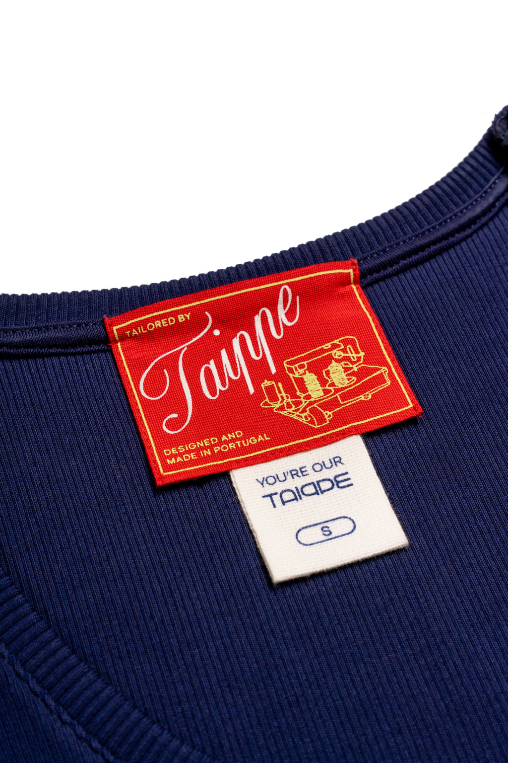 Navy tank top with a red and white label on a white background