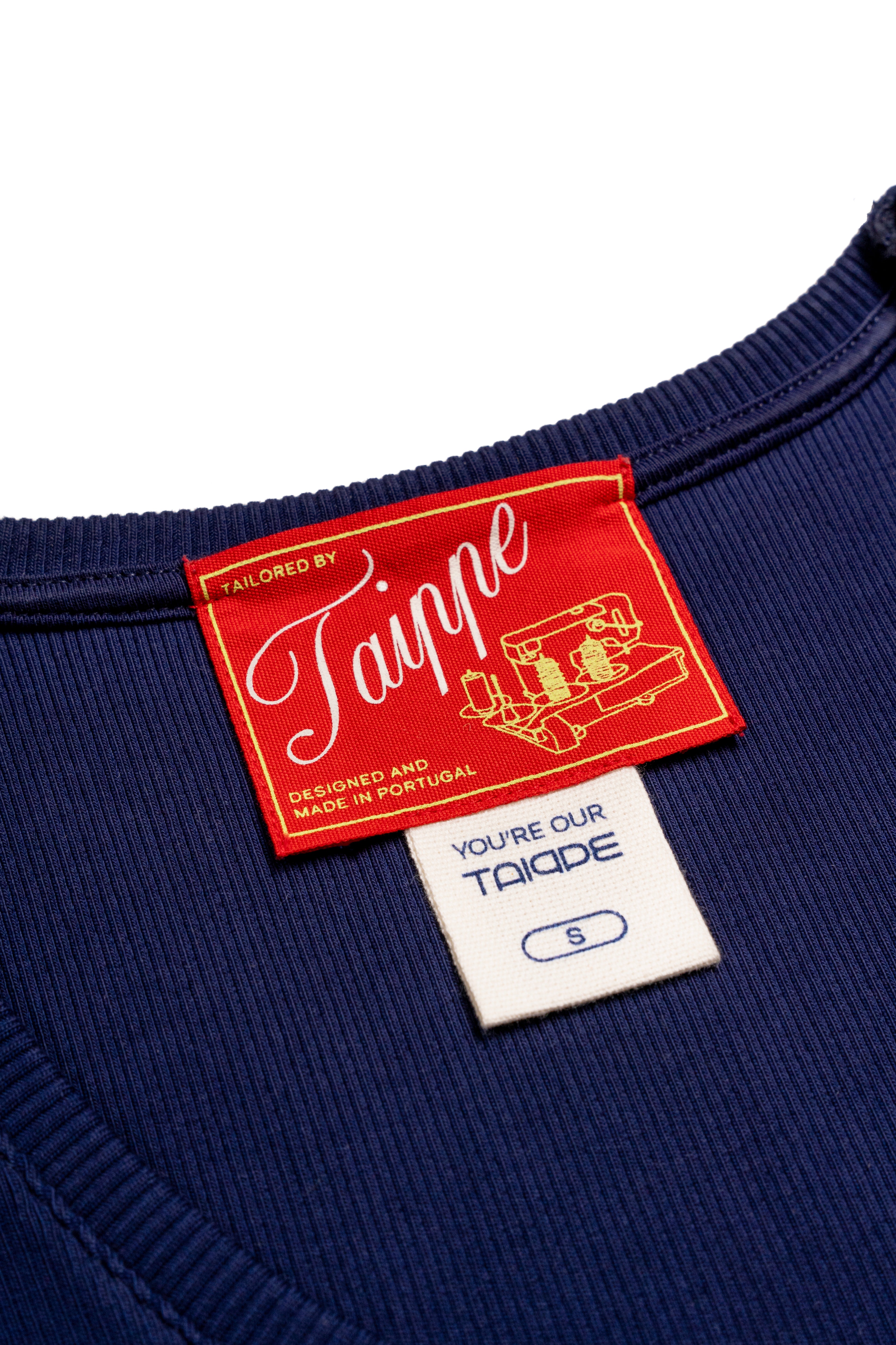 Navy tank top with a red and white label on a white background