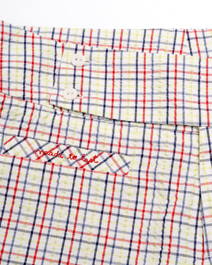 Plaid capris with red and blue lines on a white background