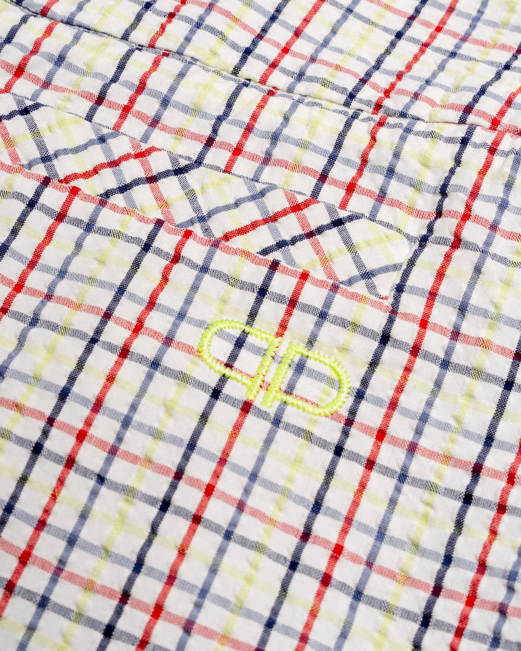 Close-up of a checkered capris with a brand logo 