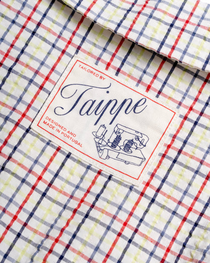Close-up of a checkered blouse with a 'Taippe' label 